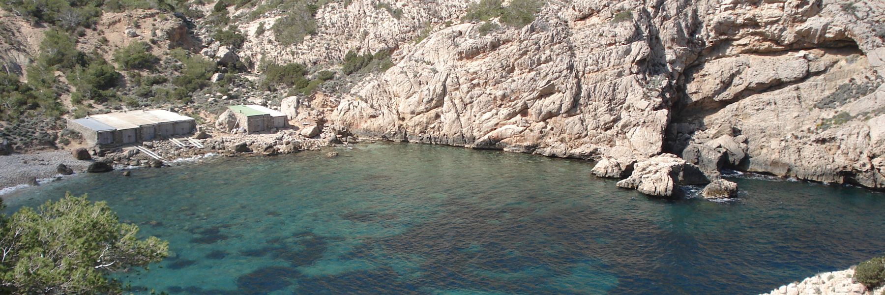 A quiet cove with fishermen's huts on Ibiza's coast