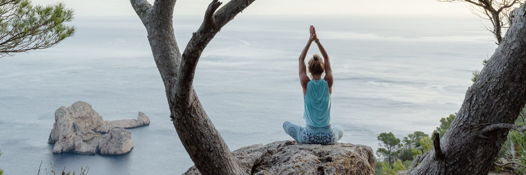 Yoga on a cliff above Ses Margalides, Ibiza
